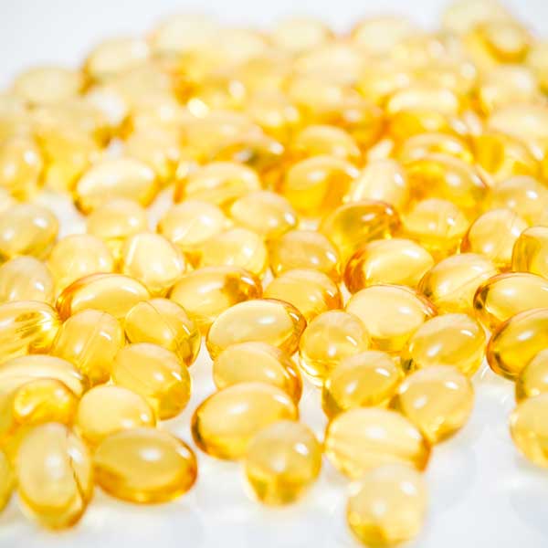 A close-up view of gelatine capsules containing fish oil.